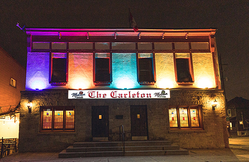 The Carleton Tavern outside photo all lit up with rainbow colour lights.